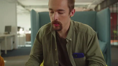 Sitting in the rest zone in the university, two students are discussing the Stock Footage 175477624
