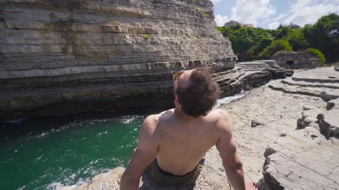Sitting on the rocks at Sea Bay. Video stock 212496053