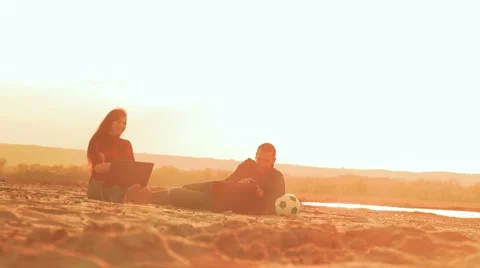 Sitting in the sand, two men ran up to him the third man slow motion video Video stock 63808259