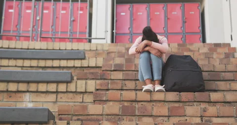 Sitting on school steps, student with backpack feeling sad and lonely, copy Stock Footage 301167071