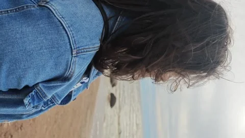 Sitting by the shore and watching the waves at the beach in summer Stock Footage 338127778