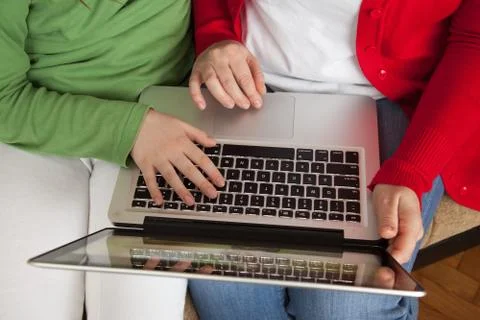 Sitting on the sofa and Internet browsing using laptop Stock Photos