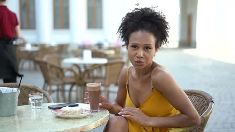 Sitting in a summer cafe having breakfast and drinking hot cocoa. Stock Footage 154451494