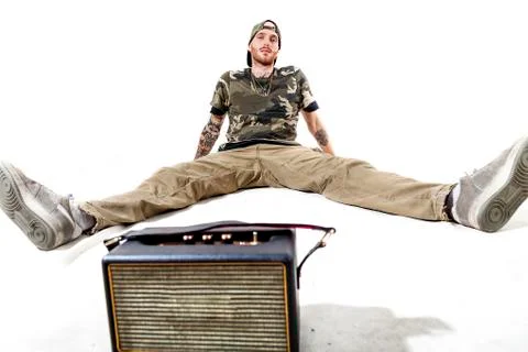 Sitting tattooed rap singer posing in studio Stock Photos