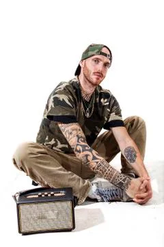 Sitting tattooed rap singer posing in studio Stock Photos