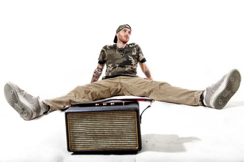 Sitting tattooed rap singer posing in studio Stock Photos