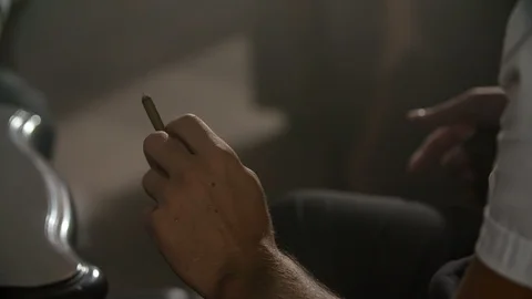Sitting there with a cigarette in his hand Stock Footage 112197523