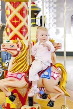 Sitting toddler on carousel 写真素材