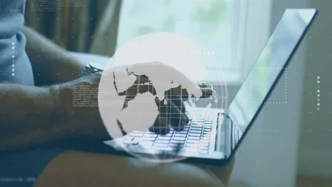 Sitting user typing keys while faint globe appearing rotating and HUD shifting Stock Footage 335282942
