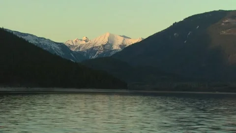 Sitting on the water looking at the mountain Video stock 304004998