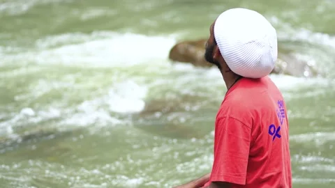 A Sitting Young Man Sitting While Wandering at a River Stock Footage 207664114