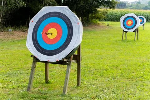 Six arows on archery target sticking in center middle on archery shooting ra Stock Photos