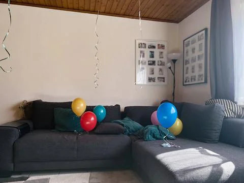 Six balloons on the couch Stock Photos