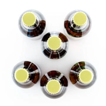 Six bottles of beer with caps facing camera Pattern of six beer bottles wi... Stock Photos