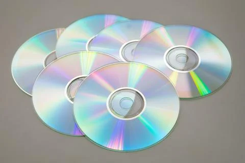 Six CDs DVDs on a gray background. Stock Photos