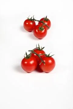 Six cherry tomatoes on white Stock Photos