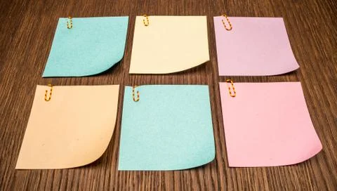 Six colorful post-it notes on wooden background. Stock Photos