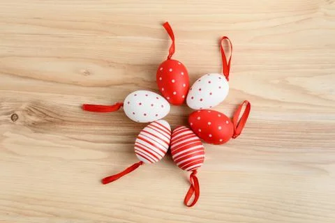 Six decorative red white Easter eggs displayed in circle on wooden background Stock Photos