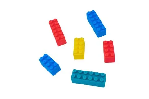 Six different colored building blocks scattered across a white isolated backg Foto stock