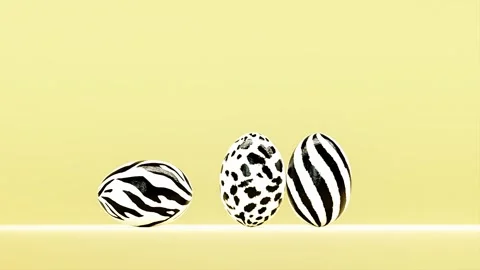 Six Easter eggs with animal skin pattern rolling over on yellow background Видео 265804581