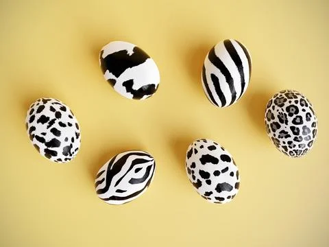 Six Easter eggs with animal skin pattern on yellow background Illustrazione stock
