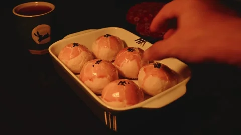 Six Egg Yolk Pastries in a Ceramic Baking Dish with Warm Light Vídeos de archivo 345669716