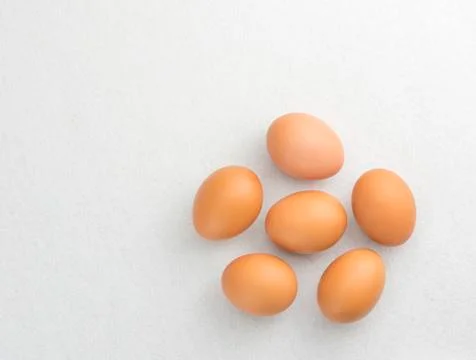 Six eggs placed on the floor isolate on white background. Stock Photos