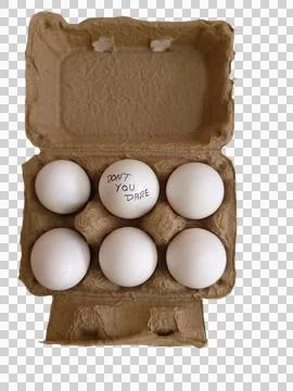 Six eggs in a tray and one of them has a slogan as "Don't you dare" Foto stock
