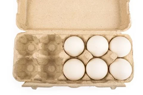Six eggs in a tray for ten eggs isolate Stock Photos