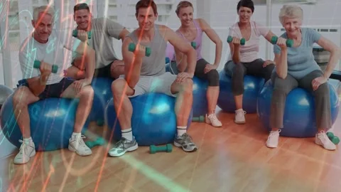 Six exercisers on instructor cue curling green weights on blue balls overlaying Stock Footage 331571228