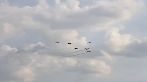 Six fighter jets in the blue sky. A general plan. Aerobatic figures. Airshow. 12 Stock Footage 124147308