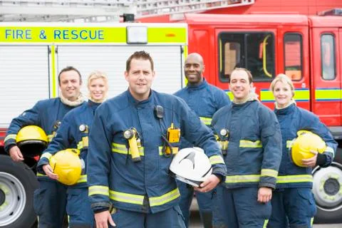 Six firefighters standing by fire engine Stock-Fotos