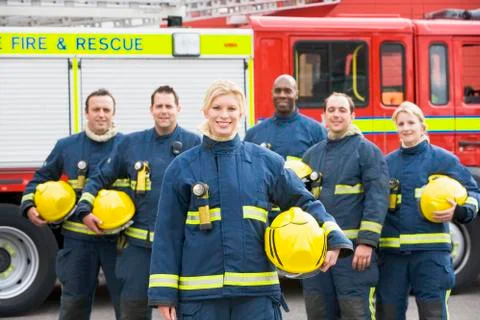 Six firefighters standing by fire engine Stock-Fotos