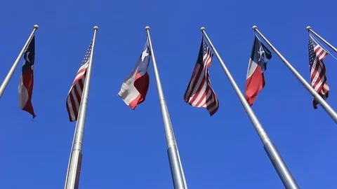 Six Flags over Texas: American and Texas Flags fluttering against blue sky Video stock 72450067