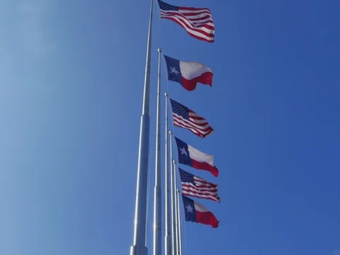 Six Flags over Texas: American and Texas Flags fluttering against blue sky Video stock 72503997