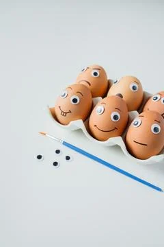 Six funny handmade Easter emoji eggs on a stand on white background close u.. Stock Photos