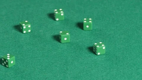 Six green dices rolling in slow motion on a green mat Stock Footage 161955424