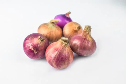 Six medium size fresh and ripe red onion isolated on a white background Stock Photos