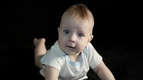Six-months caucasian type boy crawling and laughing on black background Stock Footage 71231505