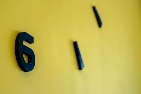 Six o'clock or numder six on yellow background Stock Photos