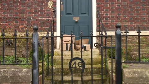 Six parcels delivered by Amazon Prime and left on the steps of a dwelling Video stock 147902835