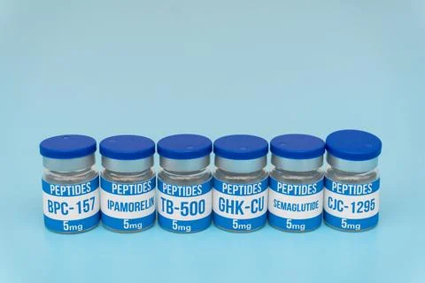 Six Peptide Vials with Different Labels on Blue Background, Studio Shot Stock Photos
