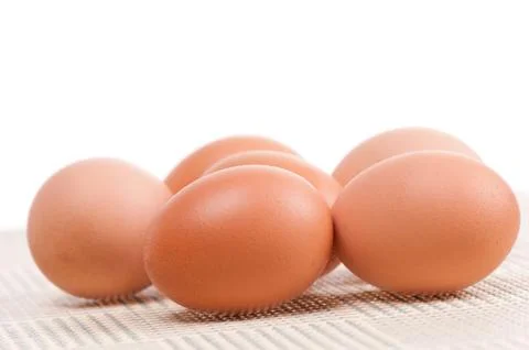 Six raw eggs in shell lying loose Stock Photos