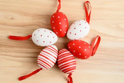 Six red decorated Easter Eggs displayed in circle on a wooden box, top view Stock Photos