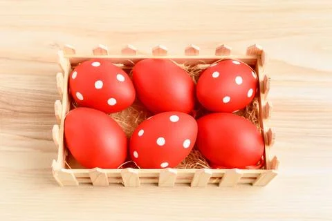Six red decorated Easter Eggs in a wooden little box on a wooden background Stock Photos