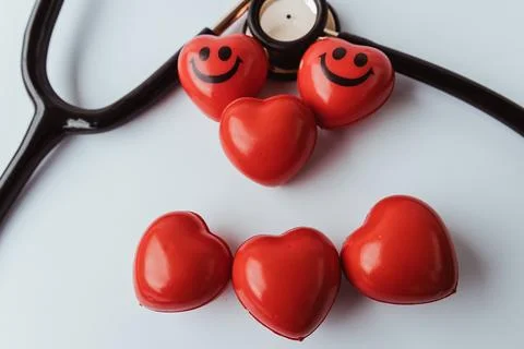 Six red hearts including two smiling ones arranged with. Stock Photos