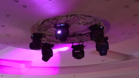 Six rotating ceiling spotlights illuminate the room with multicolored rays. Stock-Footage 248155720