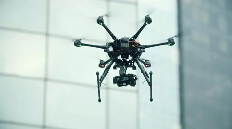 Six Rotor Drone with Camera on Gimbal flying in the Sky. Shot in Slow motion. Stock Footage 64990797
