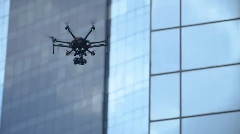 Six Rotor Drone with Camera on Gimbal flying in the Sky. Shot in Slow motion. Vídeo Stock 64990805