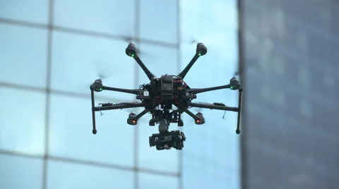 Six Rotor Drone with Camera on Gimbal flying in the Sky. Shot in Slow motion. Stock Footage 64990812